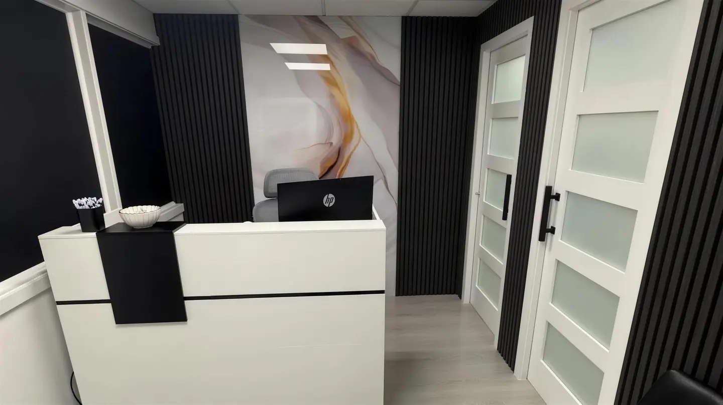 Reception desk and frosted-glass office doors in the MO Accounting Services lobby in Miami